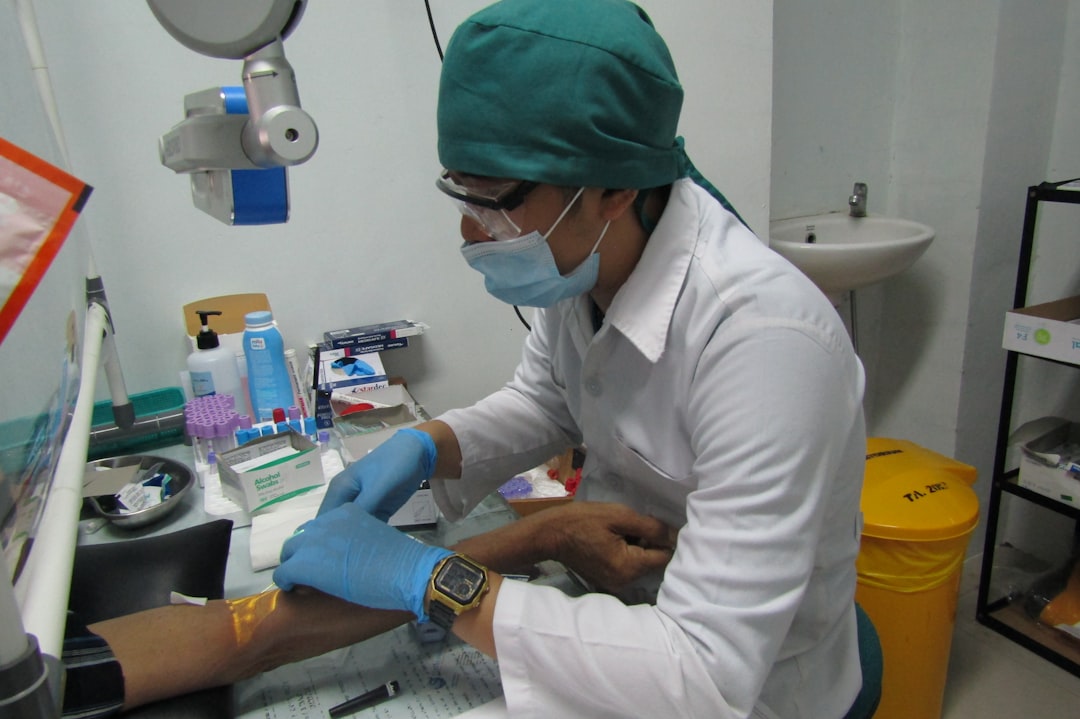 a nurse is taking blood to be checked in the hospital laboratory.